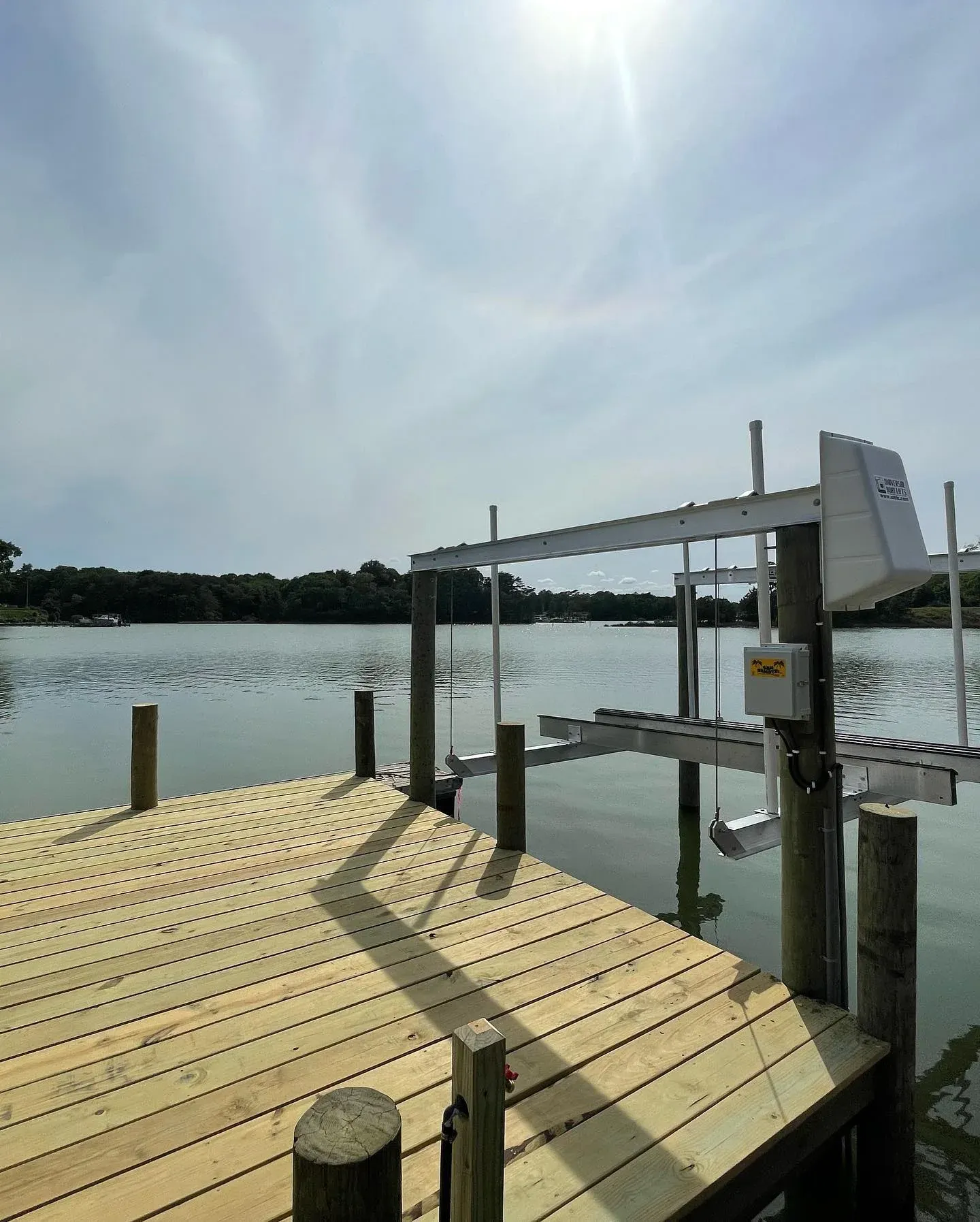 A new boat lift and pier deck over calm water